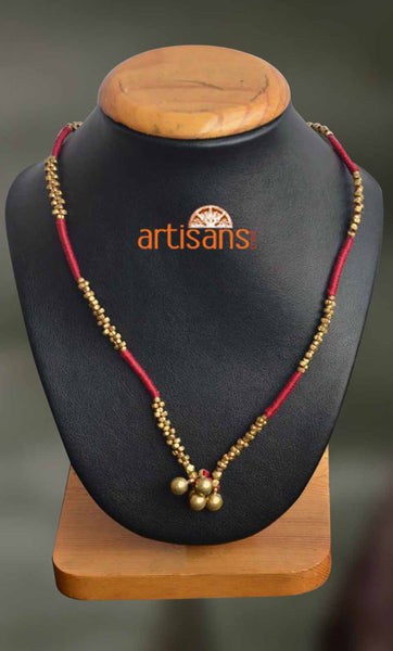 Tribal Jewellery:Necklace with golden pendant on red thread
