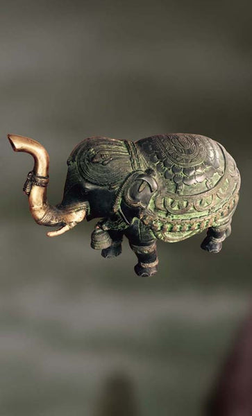 Brass sculpture of an elephant with raised trunk