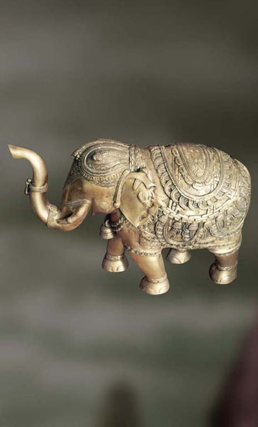 Brass sculpture of an elephant with raised trunk