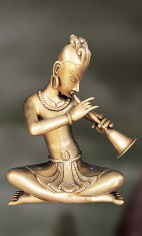 Brass Sculpture of man playing mouth organ 