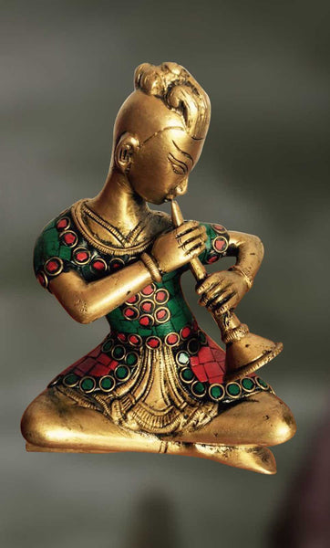 Brass and Stone Sculpture of man playing mouth organ 