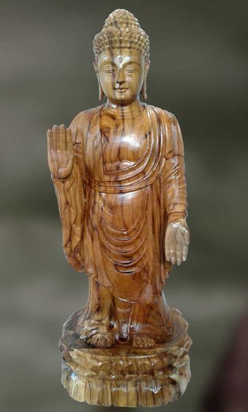 Wood sculpture of Lord Buddha blessing disciples