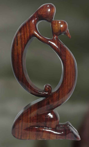 Wood sculpture of couple in physical intimacy