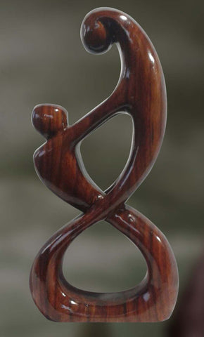 Wood sculpture of couple in intimate union