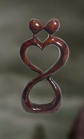 Wood sculpture of a couple expressing love