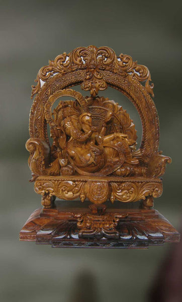 Wood sculpture of Ganesha on a pedestal