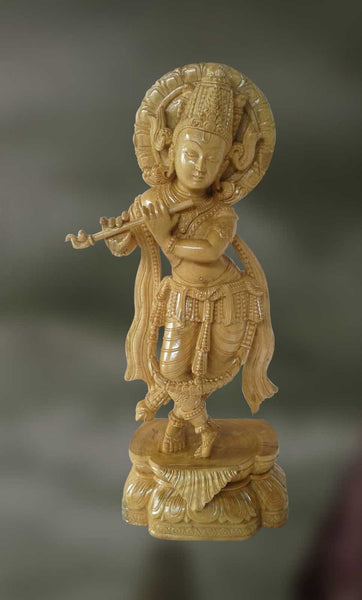 Wood sculpture of Lord Krishana playing flute