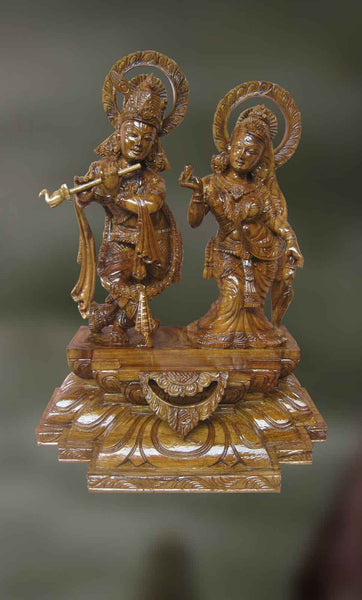 Wood sculpture of Krishna playing his divine flute