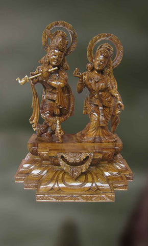 Wood sculpture of Krishna playing his divine flute