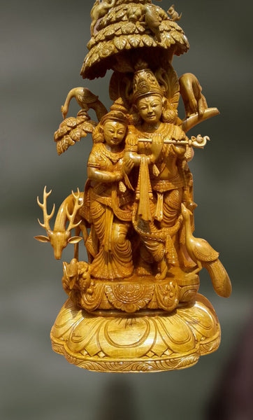 Wood sculpture of radha and krishna together 