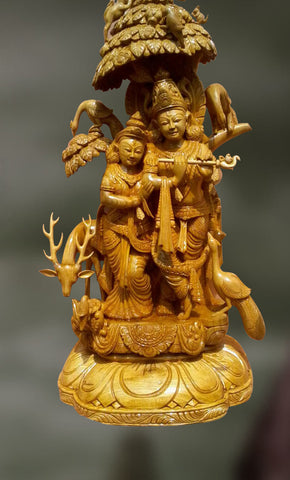 Wood sculpture of radha and krishna together 