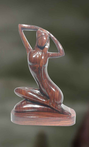 Wood sculpture of woman in a relaxed posture 